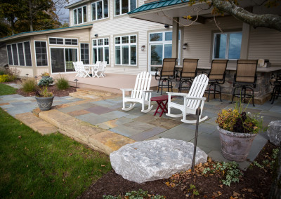 multi-level patio with outdoor kitchen bar