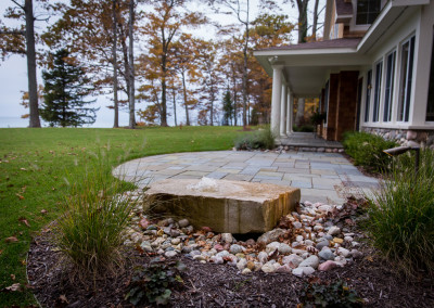 stone water fountain with landscape lighting