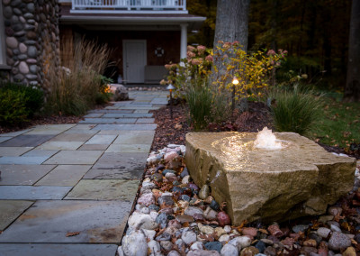 stone bubbler water fountain with landscape lighting