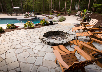 flagstone patio and firepit overlooking pool area