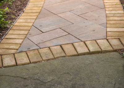 paver pathway to a built-in firepit