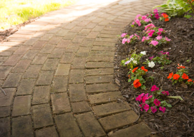 brick paver pathway with annual plantings