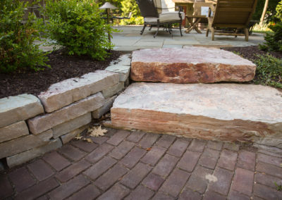 brick paver patio with stone steps