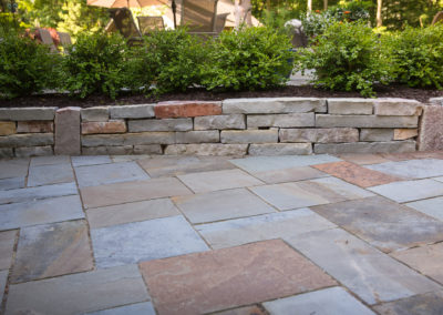 slate patio with stone wall