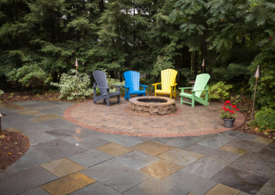 paver and natural stone patio with built in firepit