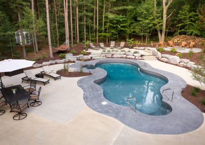 stamped concrete patio around freeform underground pool