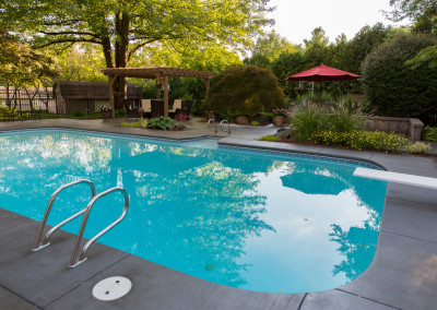 landscaped backyard with pool and pergola