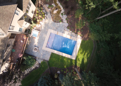 overhead aerial pool with bluestone patio and waterfall