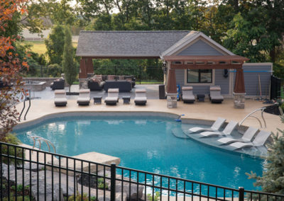 pool and pool house with privacy fence