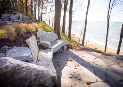 boulder seating, retaining wall and water features landscaped by essex outdoor design