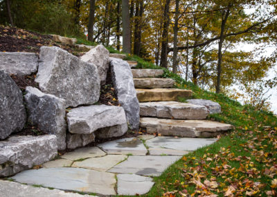 boulder seating, retaining wall and water features landscaped by essex outdoor design