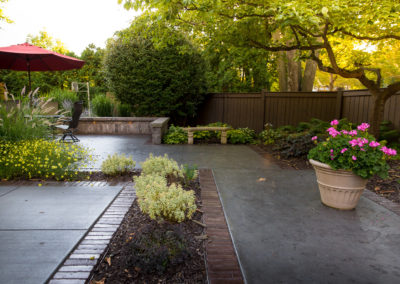 concrete pool patio, pergola and landscape lighting designed by essex outdoor design