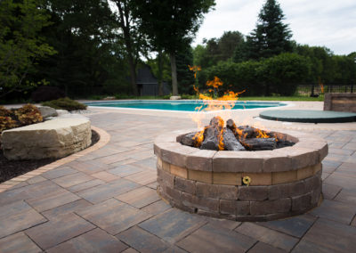 farmhouse pool retreat with gas and natural firepit landscape by essex outdoor design