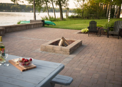 family friendly patio and firepit by the lake landscaped by essex outdoor design