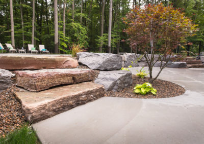 spring lake custom pool with concrete patio landscaped by essex outdoor design