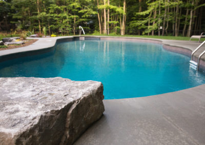 spring lake custom pool with concrete patio landscaped by essex outdoor design