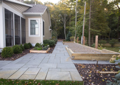 flagstone patios and built in grill overlooking Lake Michigan landscaped by essex outdoor design