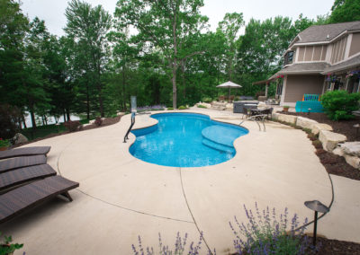 landscape design with boulder steps, pool and natural paver patio by essex outdoor design