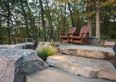 concrete patio, retaining wall and firepit overlooking muskegon river in newaygo, landscape by essex outdoor design