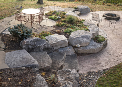 concrete patio, retaining wall and firepit overlooking muskegon river in newaygo, landscape by essex outdoor design
